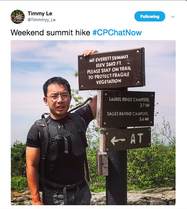 A picture of Timmy standing by the Mount Everett summit sign