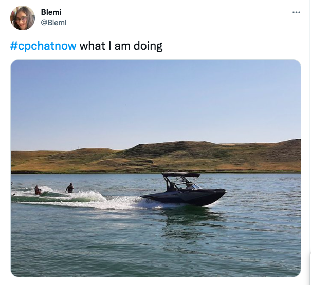blemi shares a picture of her doing adaptive waterskiing. there is a boat with two people behind the boat. 