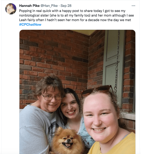 hannah tweeted she is popping in to share a happy note that she got to meet her nonbiological sister. there is a picture of hannah with her friend's mom and hannah is holding her dog levi 